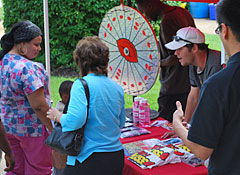 Discovery Day attendees winning prizes at the 103.7 KISS FM table