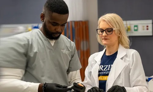 Nurse Educator Teaching Student in Labs