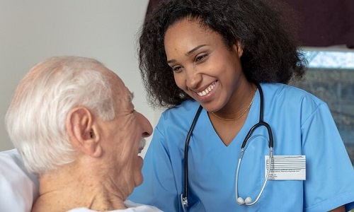 Medical Assistant Smiling with Elderly Patient