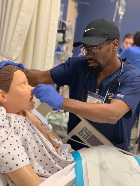 Herzing nursing student practicing procedure on simulation dummy