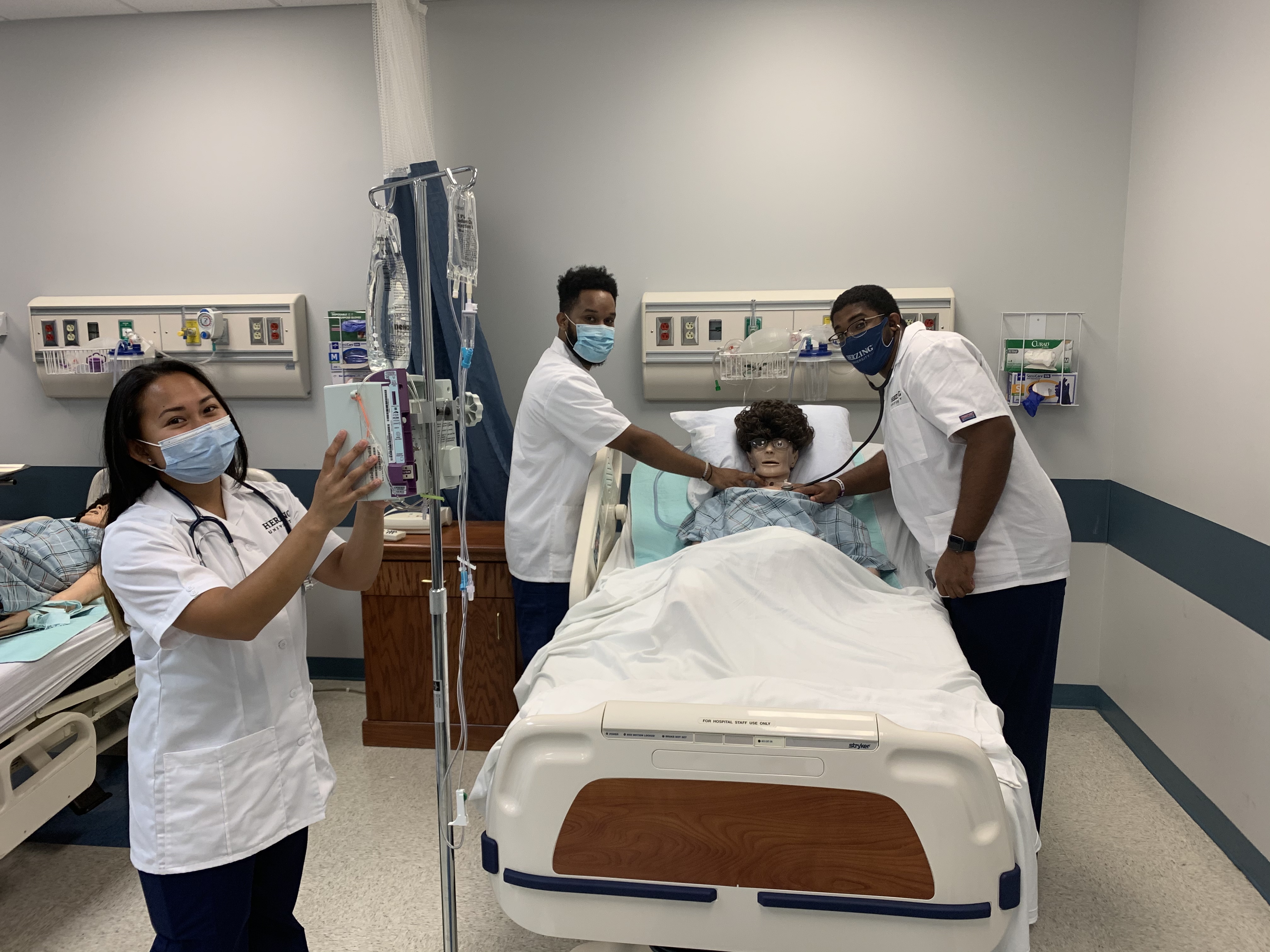 Nursing students in simulation lab using stethoscopes