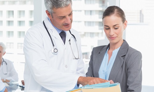 Nurse Leader Consulting with Physician About Patient Diagnosis