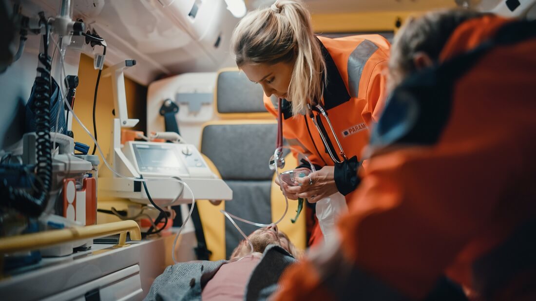 Emergency Medical Technician EMT Treating Patient in Ambulance