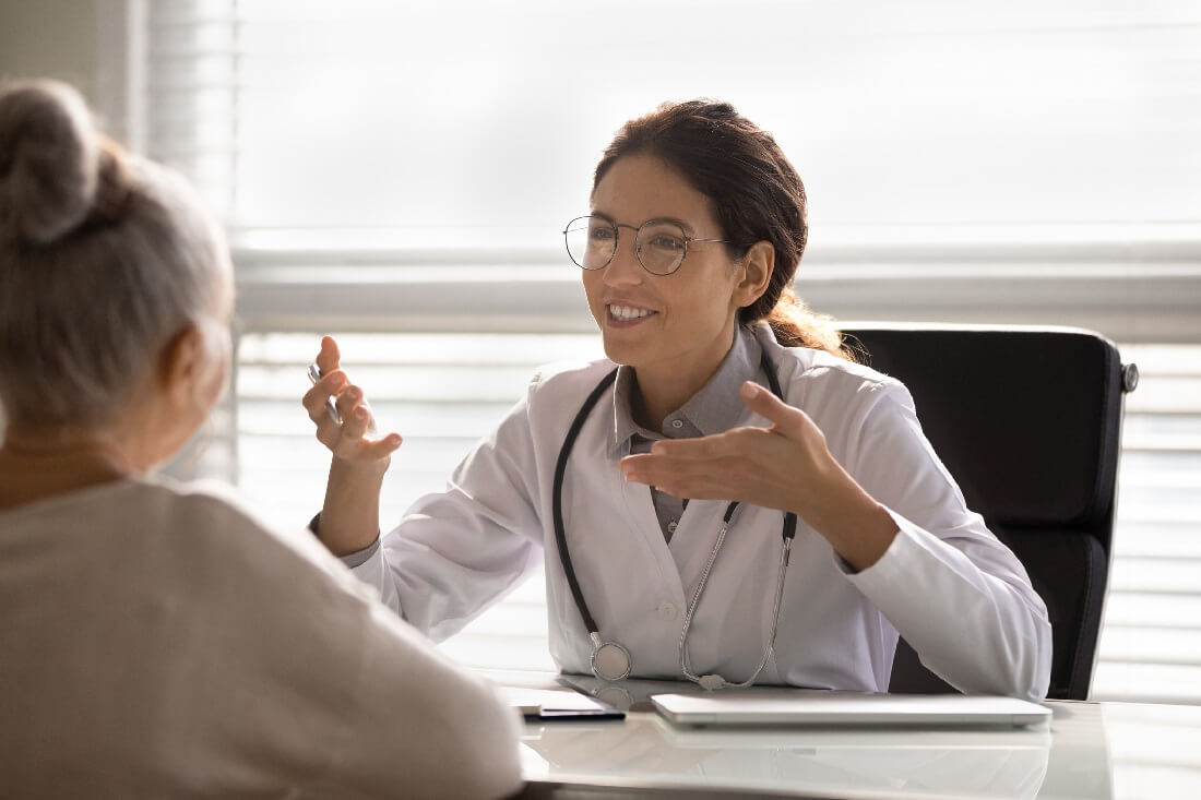 Nurse Practitioner Discussing Treatment Options with Adult Patient