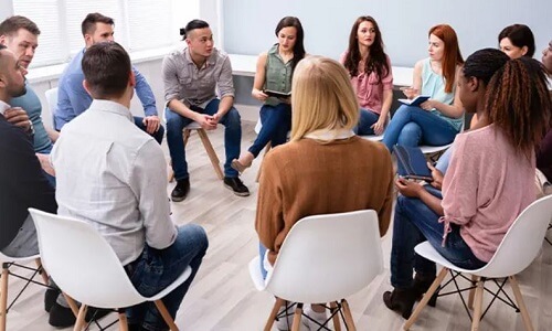 Community Discussing Local Issues with Social Worker