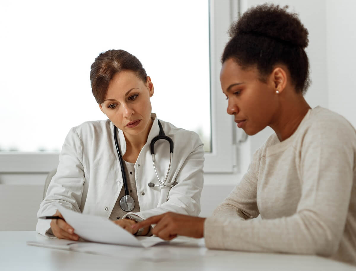 DNP Nurse Practitioner Consulting Diagnosis with Adult Patient