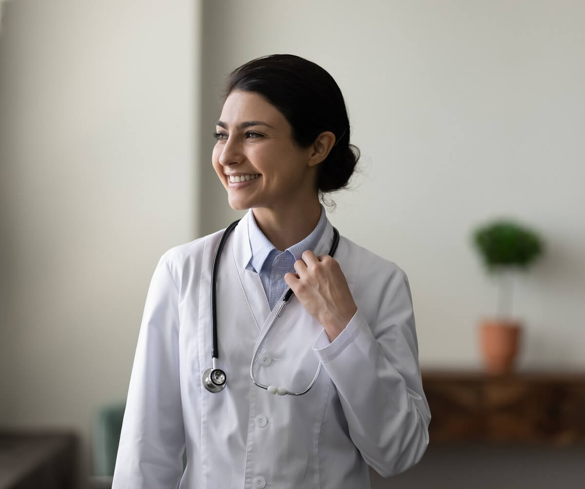 Nurse Practitioner in White Coat Smiling Nurse Practitioner in White Coat Smiling