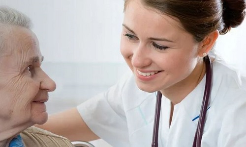 Registered Nurse Smiling with Elderly Patient