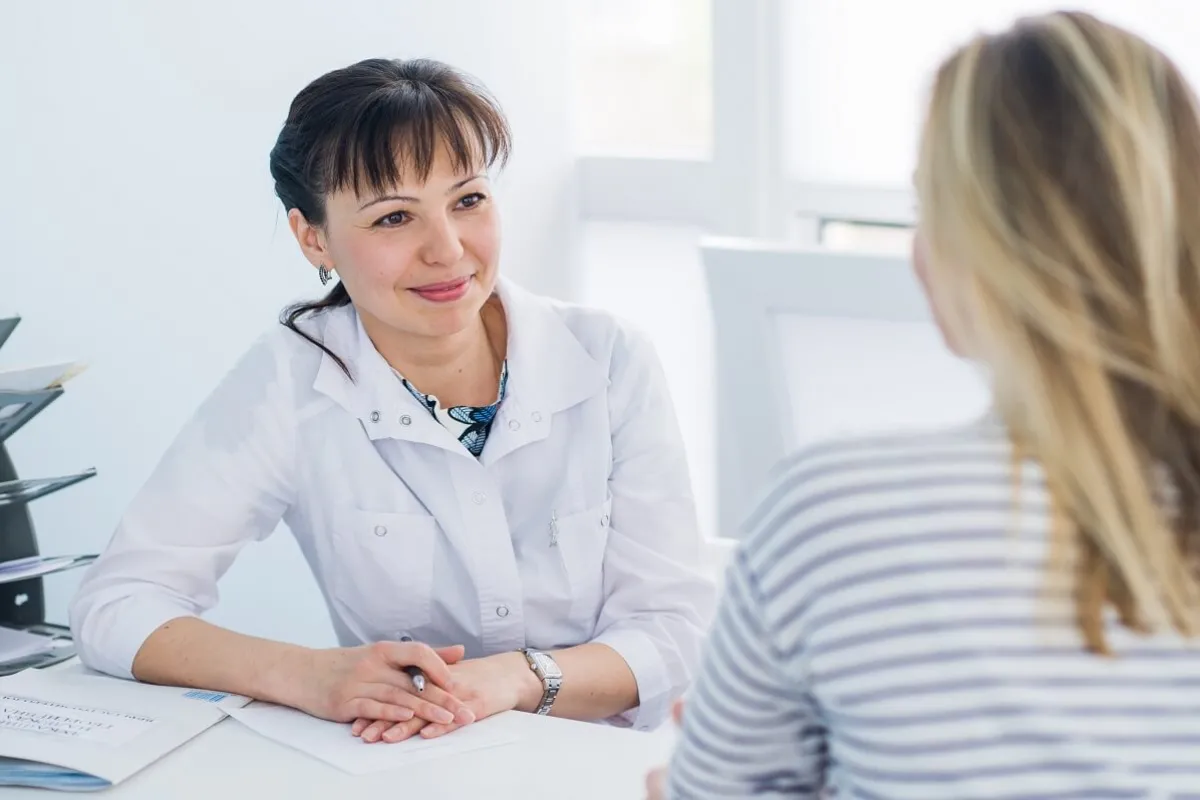 DNP Prepared Nurse Practitioner Consulting with Patient