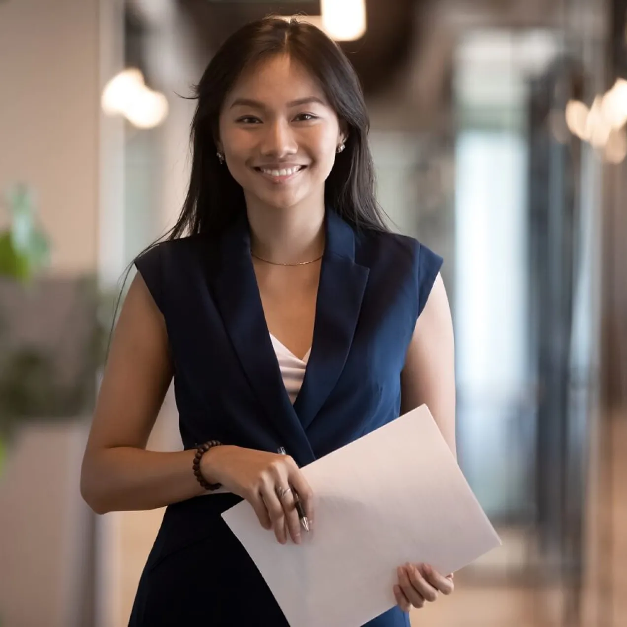Human Resources Manager Smiling and Holding Notes for Meeting