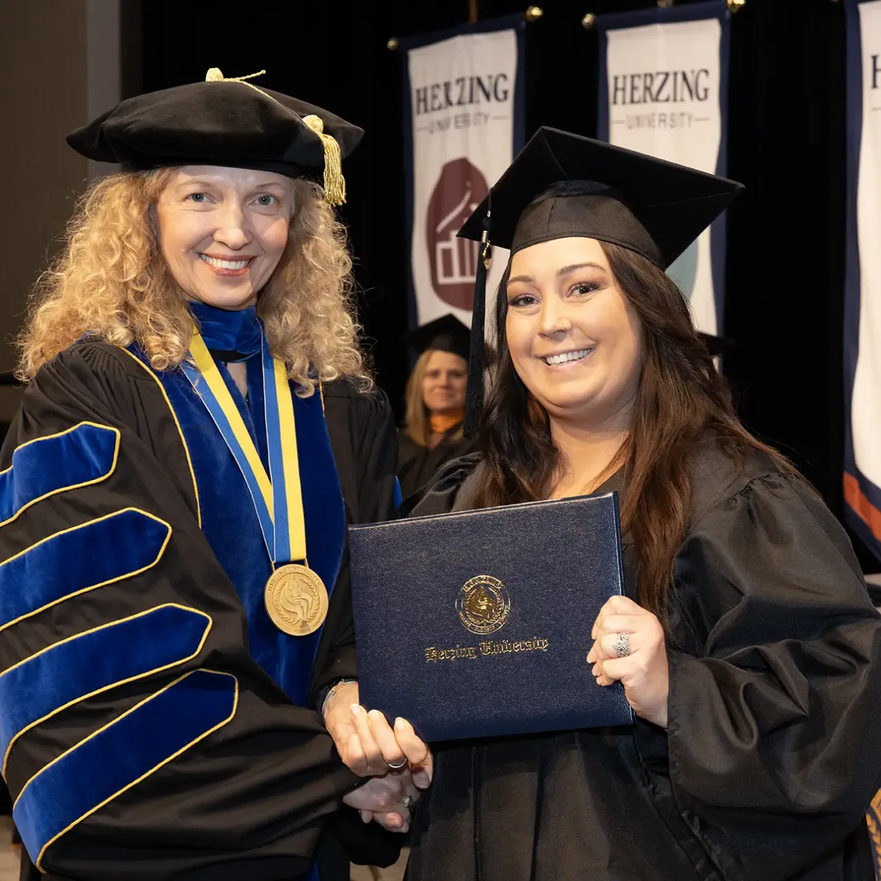 Herzing graduate with Renee Herzing