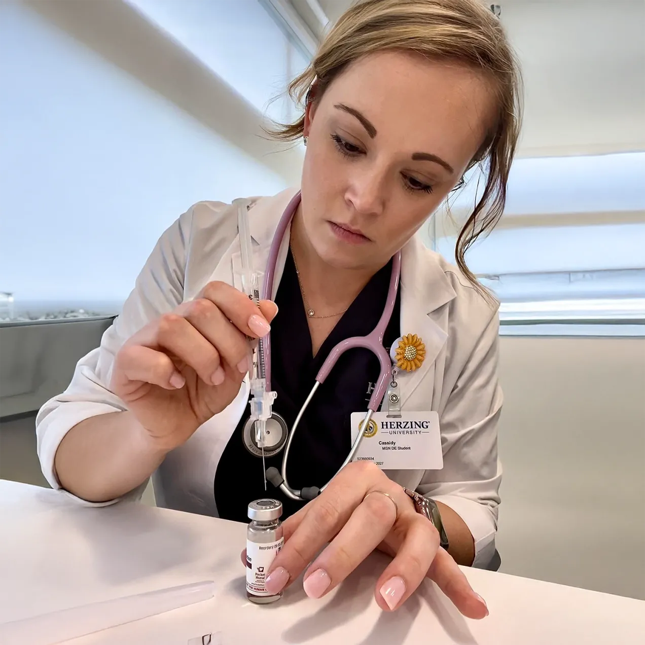 Herzing University online MSN student preparing syringe and medication in clinical lab