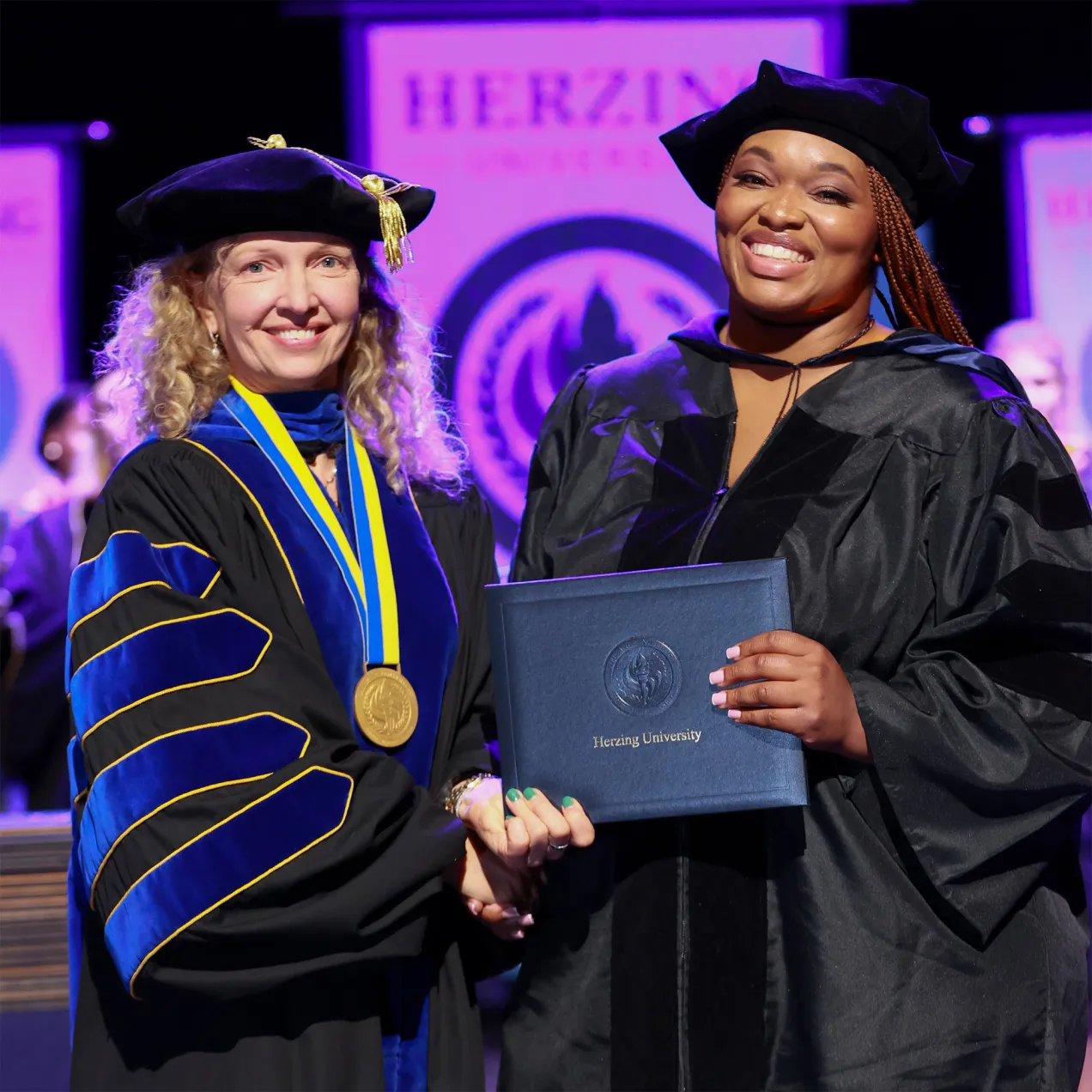 Herzing Doctoral graduate with university president Renee Herzing.