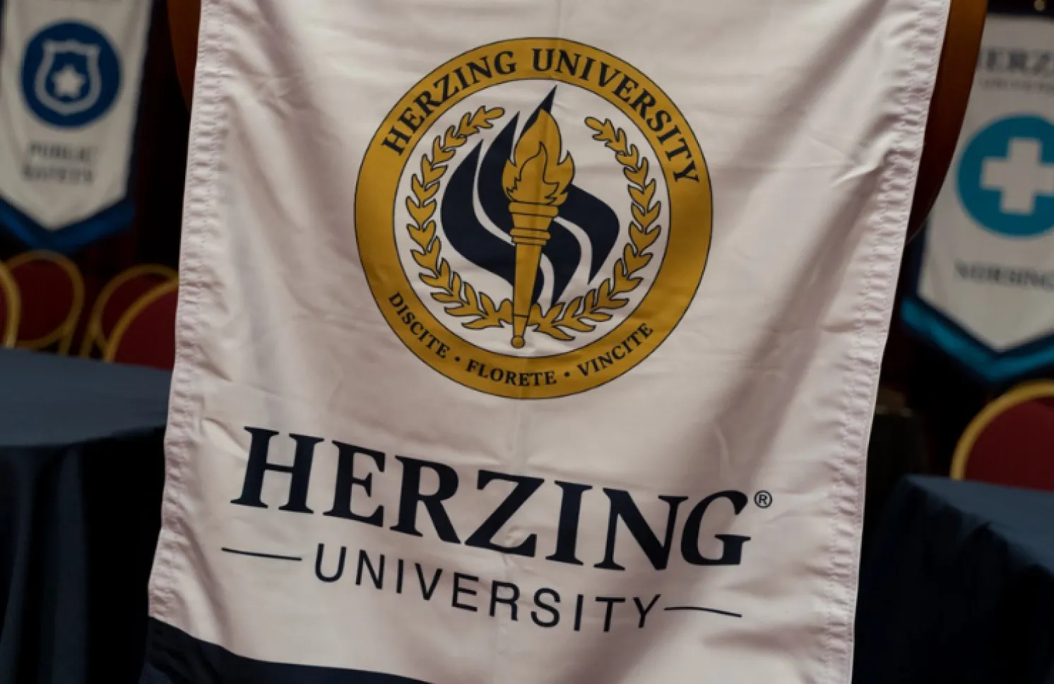 Herzing University banner at graduation