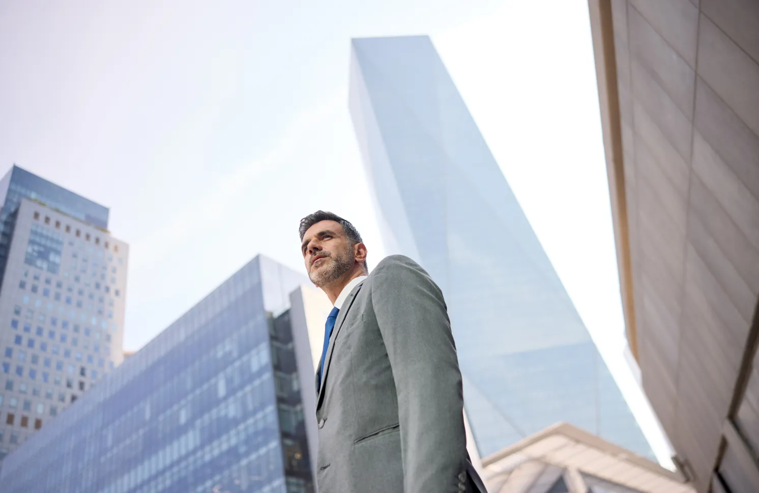 Man in a suit standing in the street.