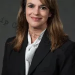 Business woman poses in a suit for a professional picture