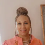 Woman poses for a picture in a peach shirt