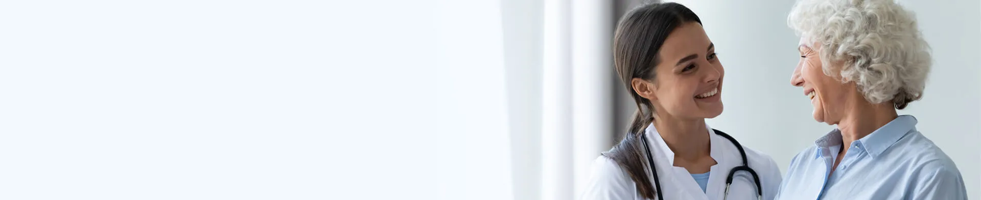 Primary Care Nurse Practitioner Smiling with Adult Female Patient