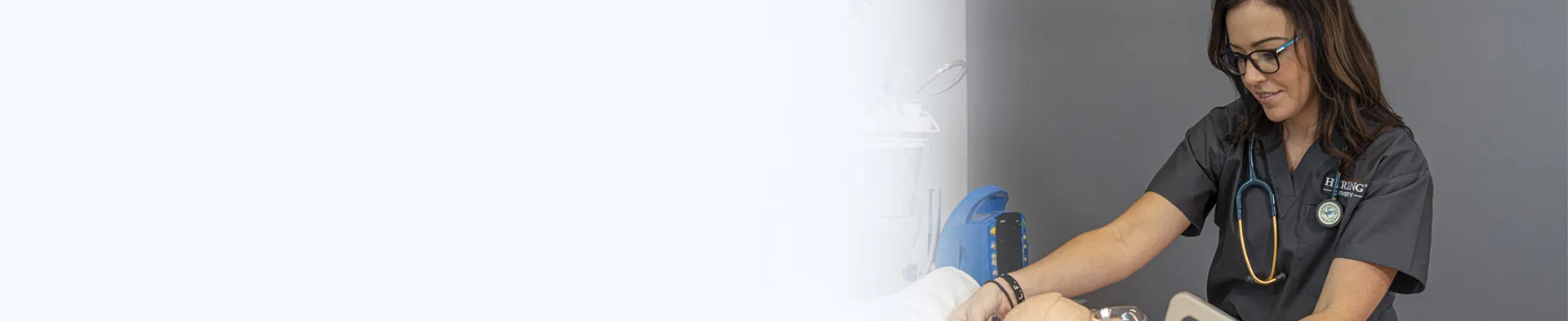 Nursing Student in Stethoscope Smiling in Nashville Nursing School Simulation Lab