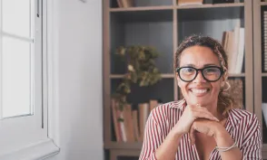 Portrait of one young and happy cheerful woman smiling looking at the camera having fun. Headshot of female person working at home in the office.