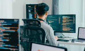 Young adult Asia male freelance eyeglasses typing write prompt AI bot IT app smart program nomad, video game, terminal with coding, user interface, designer, big data center on desktop computer.