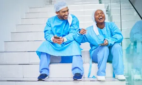urgeon, conversation and laughing on hospital stairs with phone and funny meme. Healthcare, medical and doctor team relax with comic and conversation together with mobile and social networking