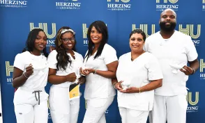 Herzing New Orleans nursing graduates smiling for photograph after commencement ceremony
