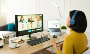 Young entrepreneur attending a virtual meeting with her team while working remotely from home