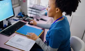 Black woman using computer to work as nurse in the private clinic.Black woman using computer to work as nurse in the private clinic.