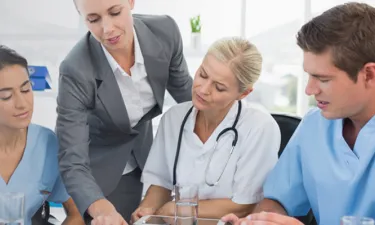 Manager with MBA in Healthcare Management in Discussion with Healthcare Staff