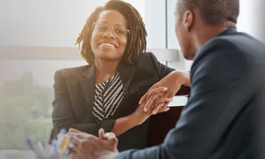 HR Manager with MBA Speaking with Employee