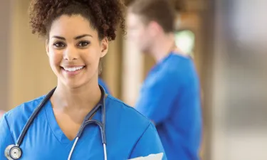 BSN Student Smiling While Completing Clinicals in Hospital
