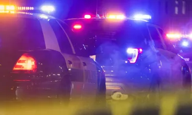 Police Cars Surrounding Crime Scene with Yellow Tape