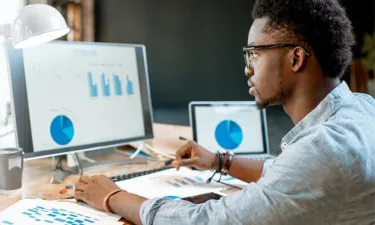 Data Analytics Student Analyzing Graphs on Computer