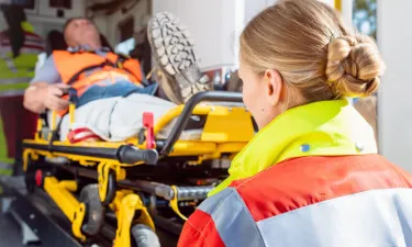 EMT Paramedic Helping Patient Into Ambulance in Birmingham Alabama