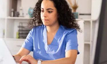 Nursing Student in Scrubs Taking MSN Direct Entry Classes Online