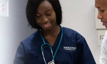 LPN Nursing Student Learning from Instructor in RN School