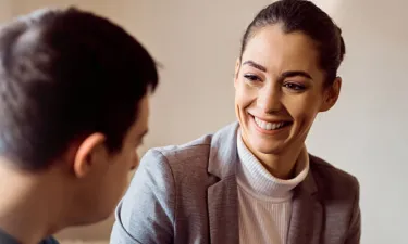 Community Worker with Psychology Degree Smiling with Male Client