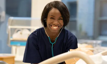 Nashville LPN to BSN Nursing Student with Stethoscope Practicing on Dummy in Simulation Lab