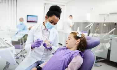 Dental hygienist who bridged from associate to bachelor's dental hygienist degree showing patient tooth structure