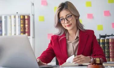 Paralegal Working on Laptop at Home