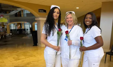 Orlando Nursing Graduates Smiling with Roses
