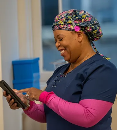 Medical assistant updating patient record.