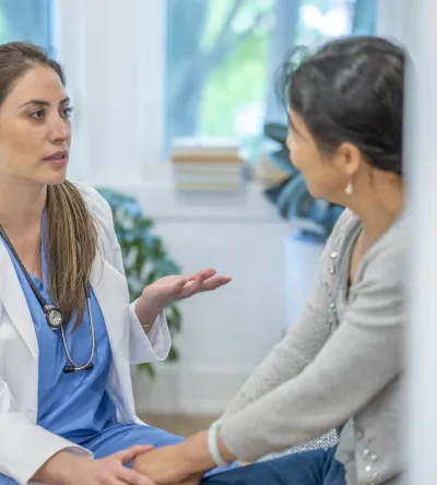 Women's health nurse practitioner discussing treatment options with patient