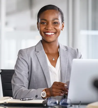 Professional woman smiling at her desk in an office setting