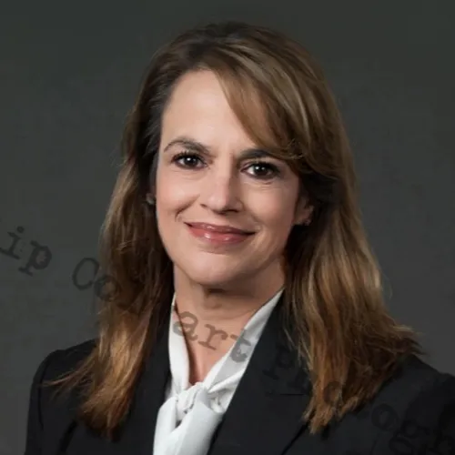 Business woman poses in a suit for a professional picture