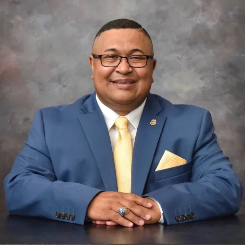 Professional image of Jose Campuzano in a suit in front of a grey backdrop
