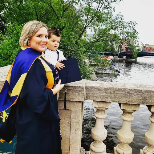 Erin Gaar holding her son overlooking a bridge