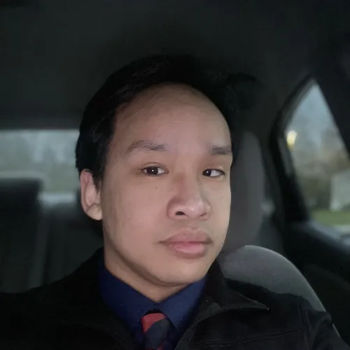 Robert Jones selfie in his car while dressed in a suit