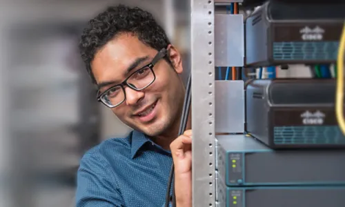 Computer Networking Professional with Bachelor's Degree Working on Server Rack